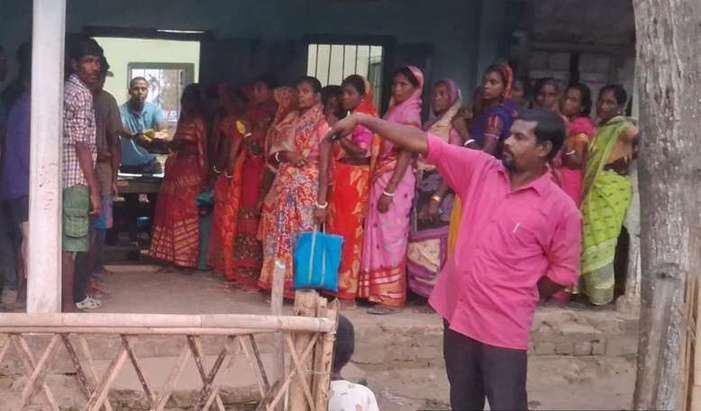 Workers lined up to receive dal and mustard oil