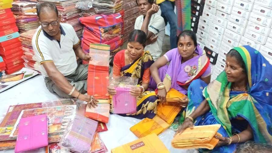 Members choosing sarees and t-shirts for distribution