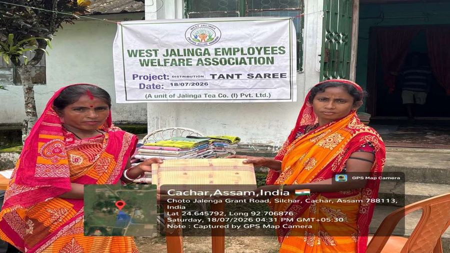 Two women receiving a handloom tant saree